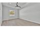 This bedroom features wood floors, a modern ceiling fan, a window, and a tray ceiling at 1172 Windjammer Dr, Lakeland, FL 33803