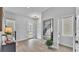 Inviting entryway with wood floors, a modern light fixture, and a sleek, oversized mirror at 1172 Windjammer Dr, Lakeland, FL 33803