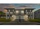 Elegant two-story duplex with a paver driveway, private balconies, and exterior lighting at 1172 Windjammer Dr, Lakeland, FL 33803