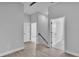 Bright hallway featuring wood floors, modern doors, and minimalist black handrail at 1172 Windjammer Dr, Lakeland, FL 33803