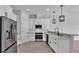 Bright kitchen with stainless steel appliances, white cabinets, subway tile backsplash, and modern lighting at 1172 Windjammer Dr, Lakeland, FL 33803