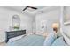 Relaxing main bedroom featuring a stylish dresser, a large mirror and ensuite bath at 1172 Windjammer Dr, Lakeland, FL 33803