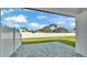 This concrete paver patio is fenced with a view of the trees, sky and neighboring homes at 1172 Windjammer Dr, Lakeland, FL 33803