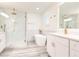 Bright bathroom features a glass shower, freestanding tub and white vanity at 11761 Bella Milano Ct, Windermere, FL 34786
