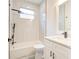 Modern bathroom with white marbled tiling, a soaking tub, and black matte hardware at 11761 Bella Milano Ct, Windermere, FL 34786