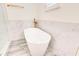 Bright bathroom features a freestanding tub, marble paneling, and gold fixtures at 11761 Bella Milano Ct, Windermere, FL 34786