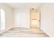 Bright bedroom featuring wood-look floors, white walls, and a closet with double doors at 11761 Bella Milano Ct, Windermere, FL 34786