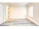 Bedroom with shuttered window, white trim, and pale gray wood-look floors at 11761 Bella Milano Ct, Windermere, FL 34786