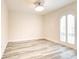 Bright and airy bedroom with wood-look floors and window with white shutters at 11761 Bella Milano Ct, Windermere, FL 34786