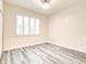 A well-lit, vacant bedroom with modern flooring and white plantation shutters over a window at 11761 Bella Milano Ct, Windermere, FL 34786