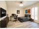 Well-organized bedroom with a desk, bed, and gaming setup at 11761 Bella Milano Ct, Windermere, FL 34786