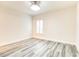 Bedroom with a modern ceiling fan, white trim, and gray-toned wood floors at 11761 Bella Milano Ct, Windermere, FL 34786