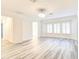 Bright bedroom with modern floors, ceiling fan, and bay windows, adjacent to the bathroom at 11761 Bella Milano Ct, Windermere, FL 34786