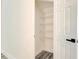 Walk-in closet with white wire shelving, fresh white paint and new flooring creating an organized space for clothing at 11761 Bella Milano Ct, Windermere, FL 34786