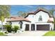 Charming two-story home featuring a terracotta roof, beautiful landscaping, and a three-car garage at 11761 Bella Milano Ct, Windermere, FL 34786