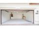 This is an empty, brightly lit two-car garage with white walls and a concrete floor at 11761 Bella Milano Ct, Windermere, FL 34786