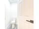 Half bathroom features a white toilet, wood-look floors, and neutral paint at 11761 Bella Milano Ct, Windermere, FL 34786