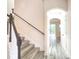 Hallway with light wood flooring and a staircase with black rails leading to the upper level at 11761 Bella Milano Ct, Windermere, FL 34786
