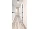 Well-lit hallway with wood-look floors, arched doorways, and white trim at 11761 Bella Milano Ct, Windermere, FL 34786