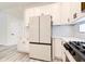 Elegant kitchen with white cabinets, stainless steel appliances, modern countertops, and sleek black hardware accents at 11761 Bella Milano Ct, Windermere, FL 34786