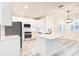 Modern kitchen with white cabinets, a large island, stainless steel appliances, and a stylish faucet and lighting at 11761 Bella Milano Ct, Windermere, FL 34786
