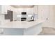 Bright kitchen features white countertops, subway tile backsplash, island with modern fixtures, and stainless appliances at 11761 Bella Milano Ct, Windermere, FL 34786