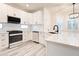 Charming kitchen featuring new stainless steel appliances, white cabinets, quartz countertops, and stylish light fixtures at 11761 Bella Milano Ct, Windermere, FL 34786