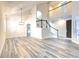 Spacious living room boasts soaring ceilings, modern light fixture, and new gray flooring throughout the downstairs living space at 11761 Bella Milano Ct, Windermere, FL 34786