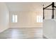 Bright living room featuring light wood flooring, white walls, plantation shutters, and a staircase at 11761 Bella Milano Ct, Windermere, FL 34786