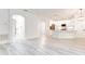 Bright open floorplan with modern light fixtures connecting the living room to the kitchen with white cabinetry at 11761 Bella Milano Ct, Windermere, FL 34786