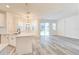 Open-concept living space combines kitchen with sleek white cabinets, gray floors, and lots of natural light at 11761 Bella Milano Ct, Windermere, FL 34786