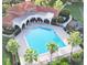 Aerial view of a community pool featuring lounge chairs, palm trees, and a playground at 11761 Bella Milano Ct, Windermere, FL 34786