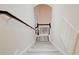 Bright and airy staircase with wood railing and gray wood-look flooring at 11761 Bella Milano Ct, Windermere, FL 34786