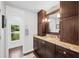Bathroom features granite countertops, dark wood cabinets, and modern fixtures at 1307 Fairlee St, Lakeland, FL 33813