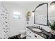 Bright bathroom featuring a black and white shower curtain and dark countertop at 1307 Fairlee St, Lakeland, FL 33813