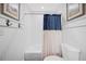 Clean bathroom featuring wainscoting, subway tile, and a stylish shower curtain at 1307 Fairlee St, Lakeland, FL 33813