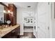 Beautiful bathroom showcasing granite counters, dark cabinets, and wood flooring at 1307 Fairlee St, Lakeland, FL 33813