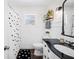 Bright bathroom featuring a black and white shower curtain and dark countertop at 1307 Fairlee St, Lakeland, FL 33813