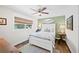 Cozy bedroom with neutral walls, a ceiling fan, and a large window at 1307 Fairlee St, Lakeland, FL 33813