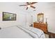 Comfortable bedroom featuring a ceiling fan, hardwood floors, and a light color scheme at 1307 Fairlee St, Lakeland, FL 33813