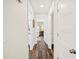 Hallway with wood floors and white trim leading to bedrooms and other areas of the home at 1307 Fairlee St, Lakeland, FL 33813