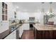 Kitchen showing a black countertop, an island and white cabinets at 1307 Fairlee St, Lakeland, FL 33813
