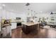 Open kitchen with stainless steel appliances, dark wood floors, and a view to the living area at 1307 Fairlee St, Lakeland, FL 33813