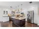 Bright kitchen featuring white cabinets, stainless steel appliances, and a large island with granite countertop at 1307 Fairlee St, Lakeland, FL 33813
