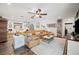 Bright living room showcasing a tan leather sectional, hardwood floors, and stylish decor at 1307 Fairlee St, Lakeland, FL 33813
