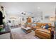 Open-concept living room featuring brick accent wall, tan leather sofa, and decorative accents at 1307 Fairlee St, Lakeland, FL 33813