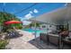 Backyard oasis with a sparkling pool, covered patio, and lush landscaping at 1307 Fairlee St, Lakeland, FL 33813
