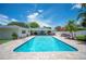Backyard pool featuring brick patio, outdoor seating, and mature landscaping at 1307 Fairlee St, Lakeland, FL 33813