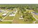 Aerial view of a rural property featuring multiple structures surrounded by lush greenery at 13522 Rockridge Rd, Lakeland, FL 33809