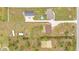 Aerial shot showcasing multiple buildings, a pool, and ample land at 13522 Rockridge Rd, Lakeland, FL 33809